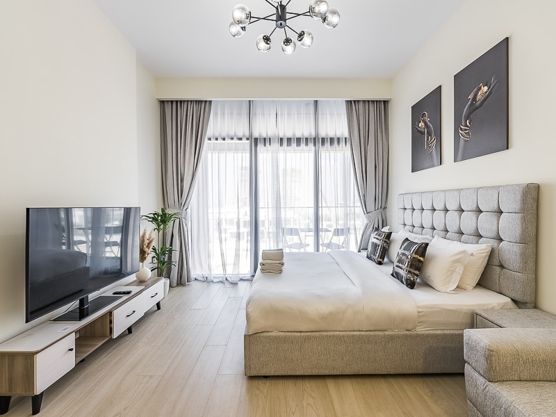 Studio living area with king bed sofa and balcony view