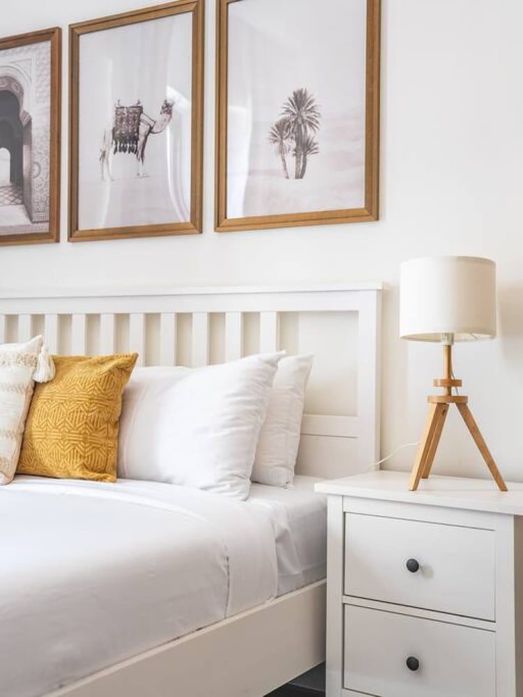 Bedroom with double bed and framed art above headboard