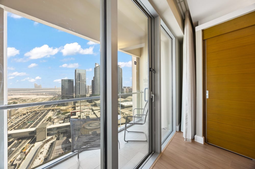 Balcony with city view and two chairs