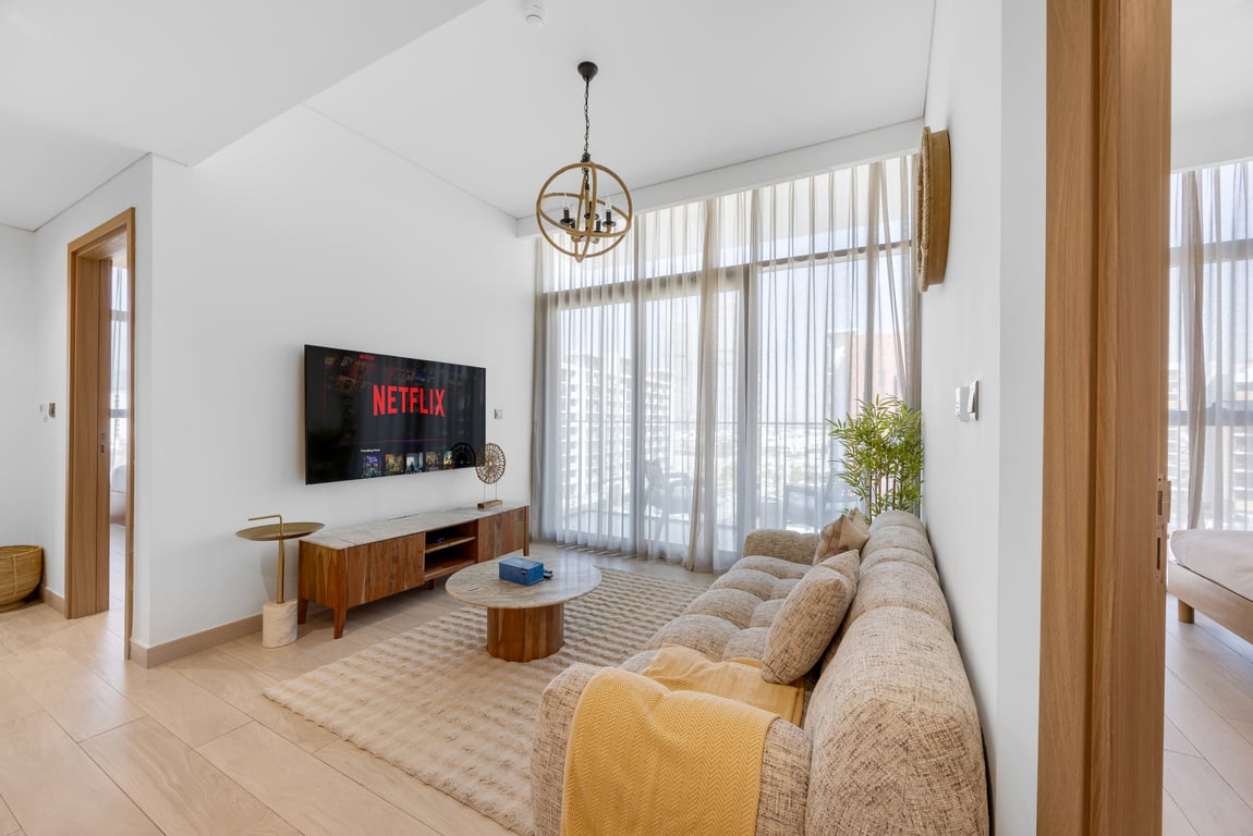 Living room with sofa TV and large window