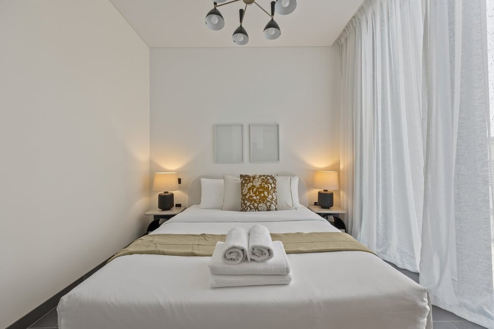Bedroom with double bed nightstands and curtains