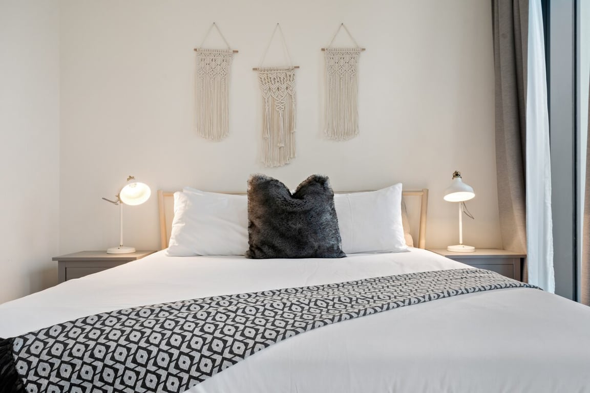 Bedroom close-up of king bed with decorative pillows