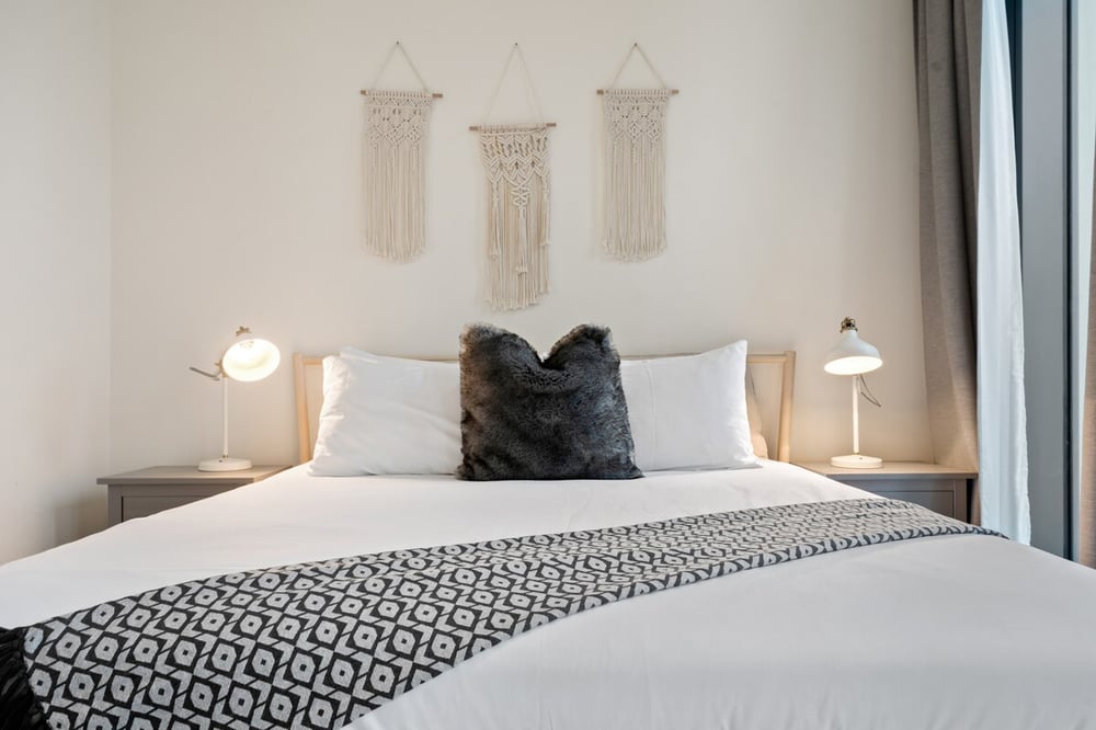 Bedroom close-up of king bed with decorative pillows