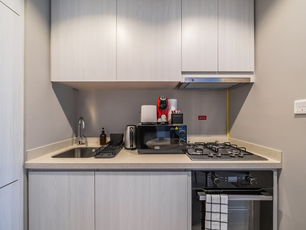 Compact kitchen with gas hob microwave and Kitchen hood