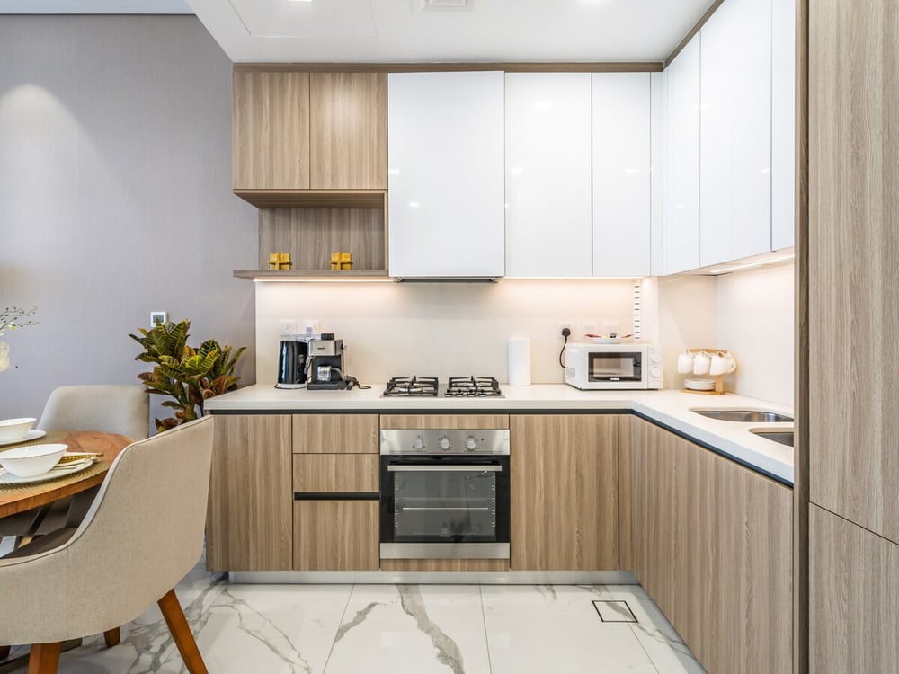 Fitted kitchen with oven hob and dining table