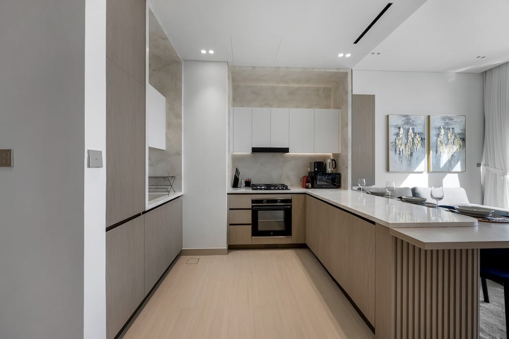 Kitchen with island counter, oven and window