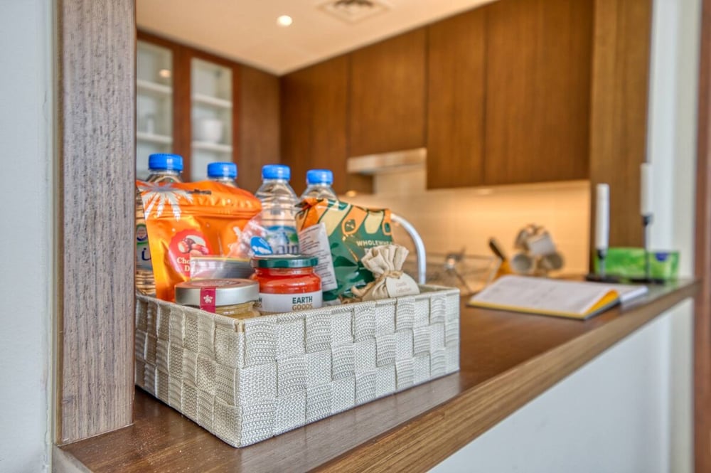 Kitchen counter with welcome basket of bottled water and supplies