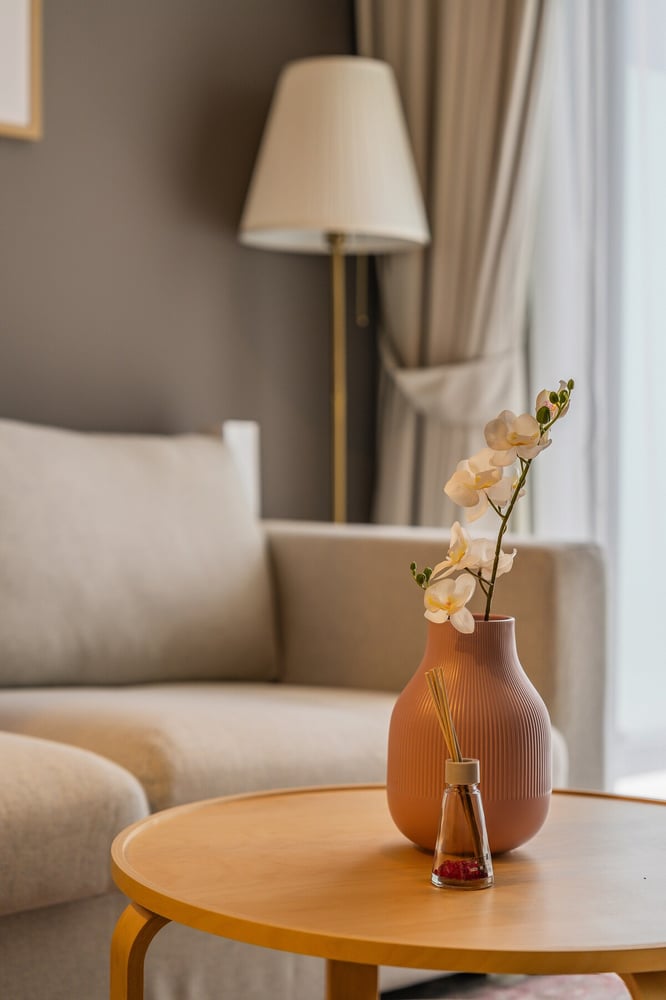 Coffee table with vase and floor lamp in living area
