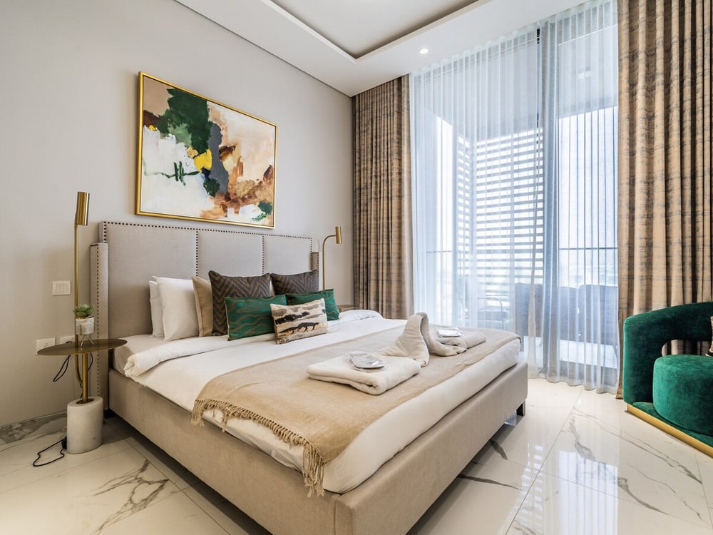 Bedroom with double bed artwork and large window