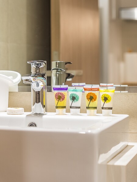 Bathroom sink close-up with toiletry bottles