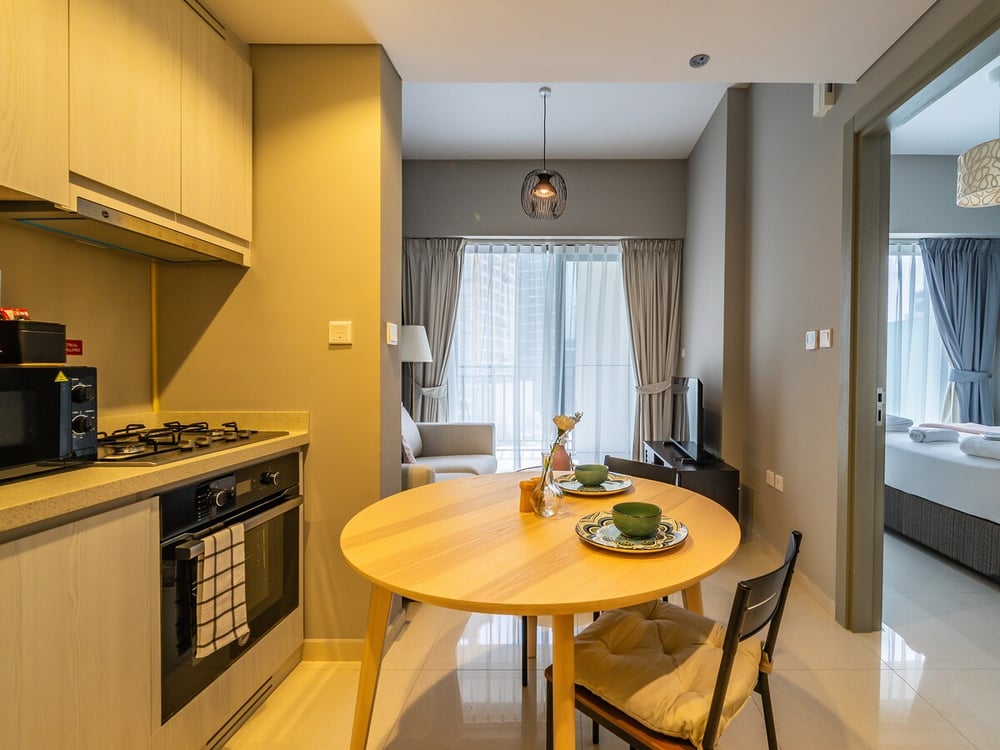 Dining area with round table chairs and kitchen and living room