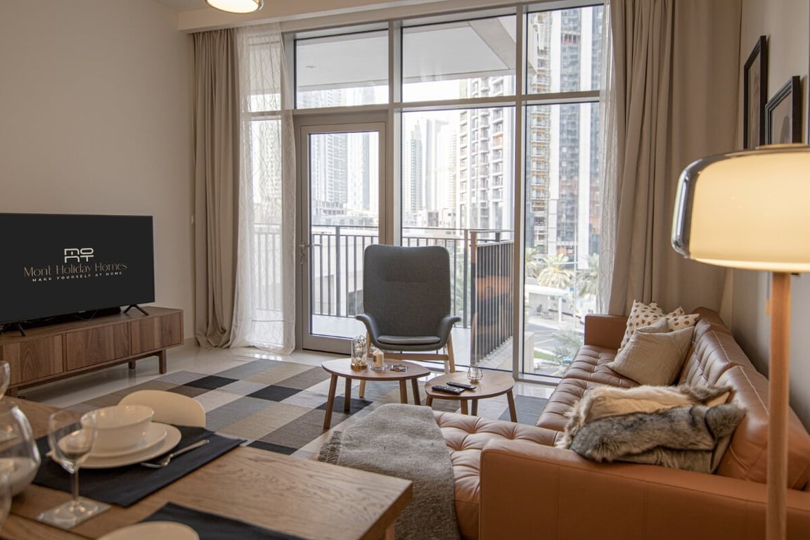 Living room with sofa, TV, floor lamp and balcony view