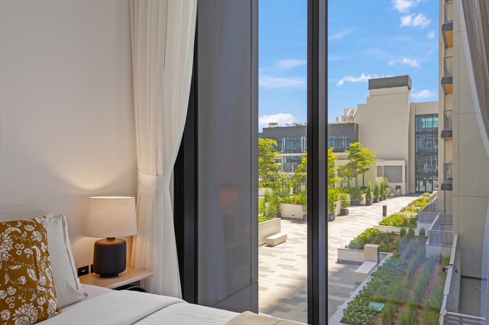 Bedroom window with balcony and city view