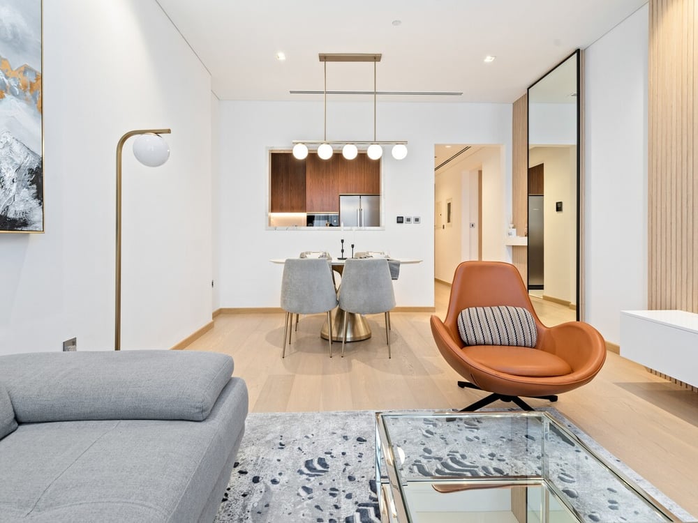 Open-plan living area with dining table and kitchen beyond