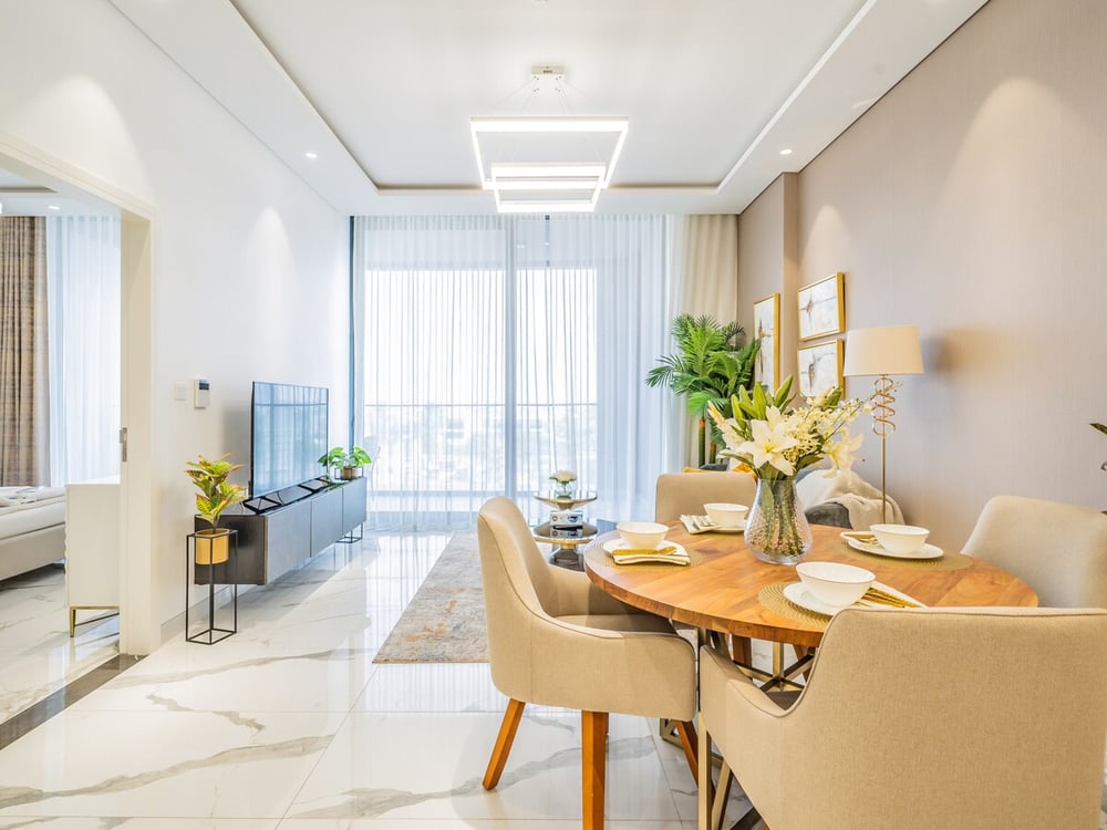 Dining area with round table and city view beyond