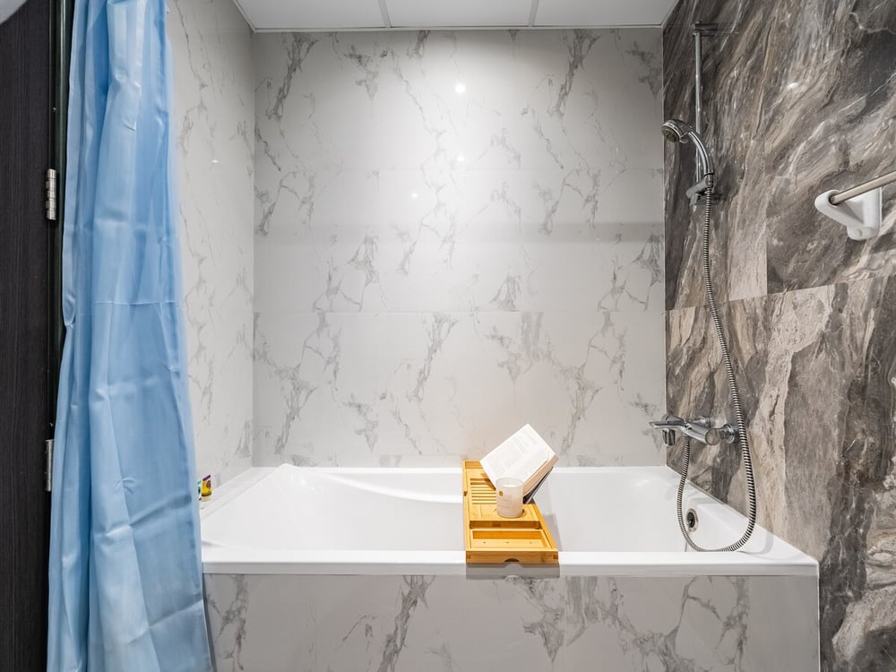 Marble bathroom bathtub with shower and curtain