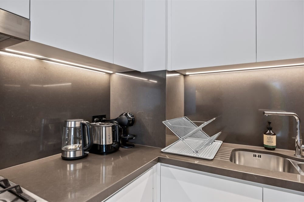 Kitchen countertop with kettle, coffee maker and sink