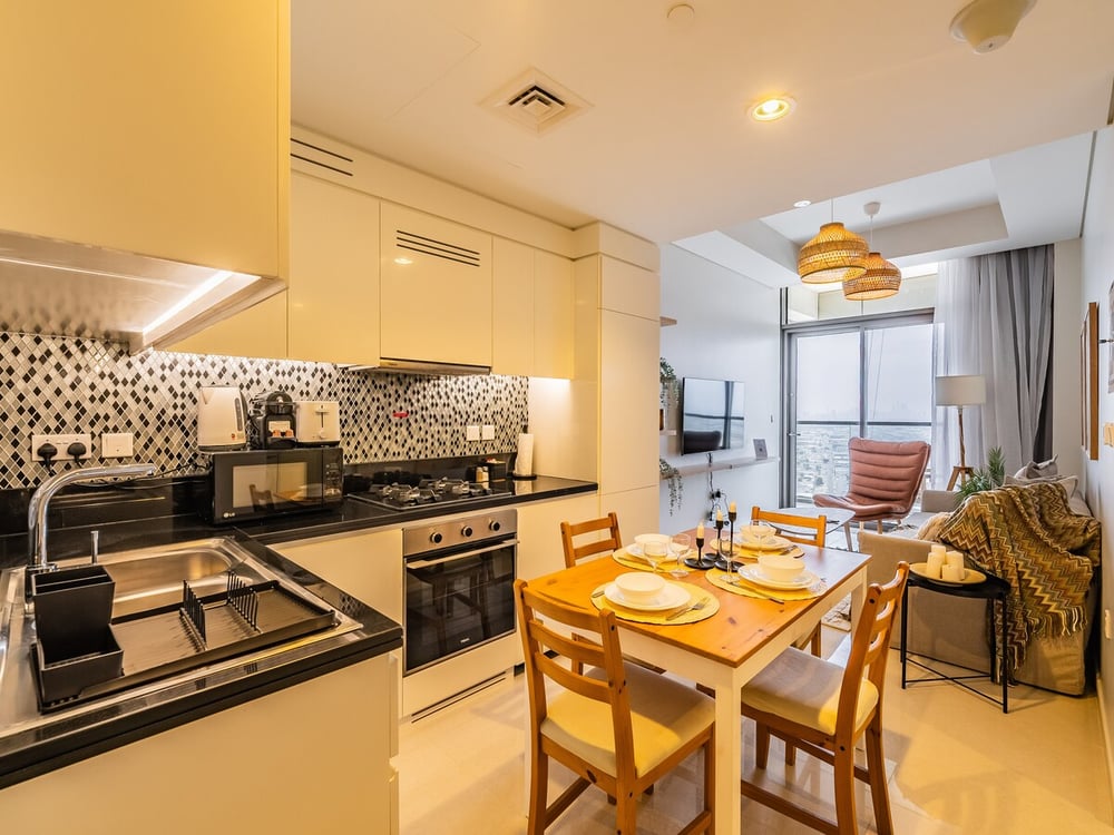 Open-plan kitchen and dining area with wooden table and chairs