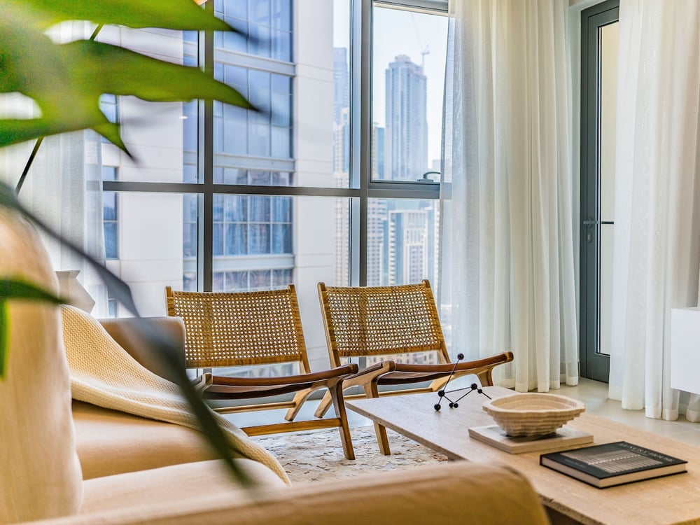 Living area armchairs and city skyline view