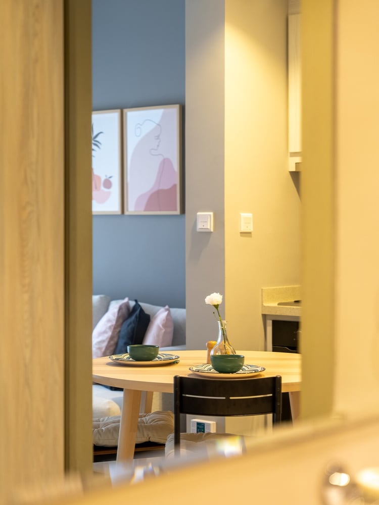 Glimpse into living area through doorway showing sofa and table