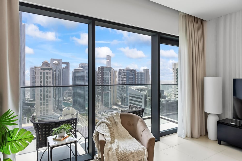 Living room corner with armchair and city skyline view