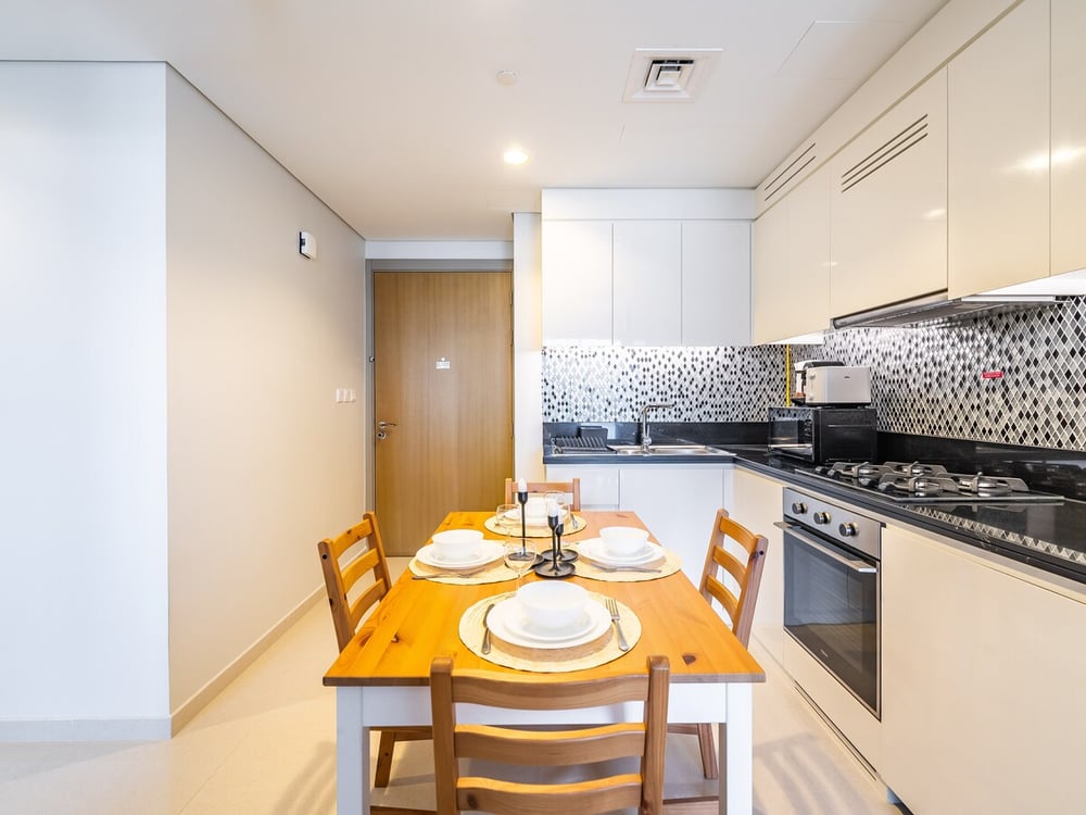 Kitchen and dining table set for meals in open-plan space