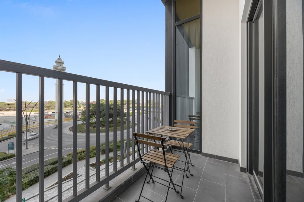 Balcony with bistro furniture and city street view