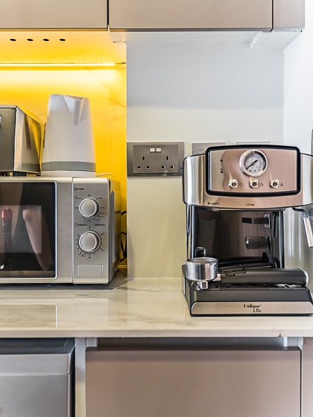 Microwave and coffee maker on kitchen counter