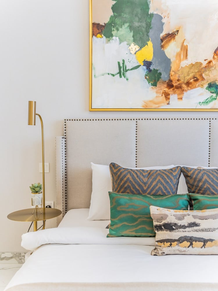 Bedroom headboard with green and grey cushions