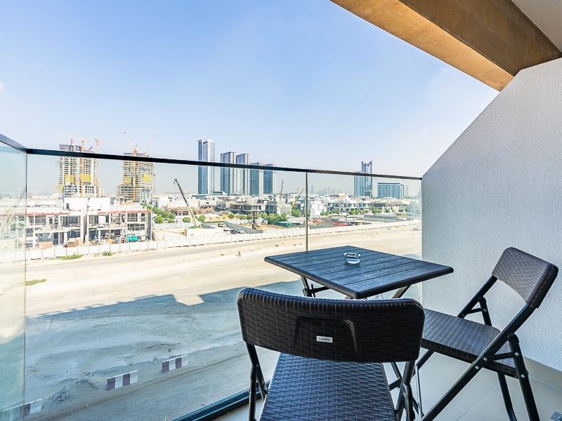 Balcony with table chairs and urban view