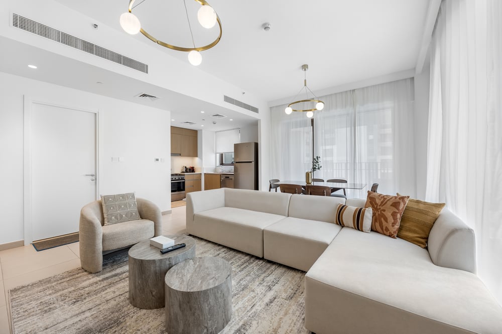 Bright open living room with large sofa and pendant light