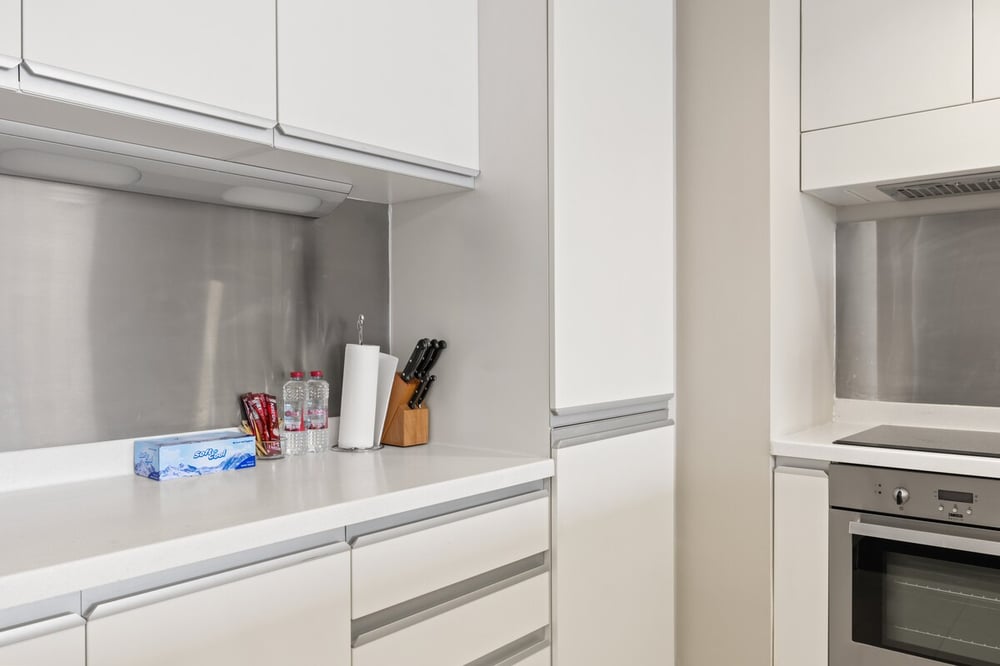 Kitchen counter with knives, oven and appliances
