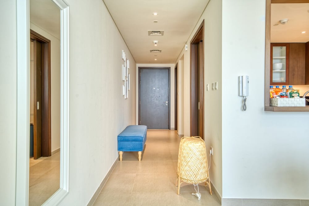 Entrance hallway with mirror and blue bench