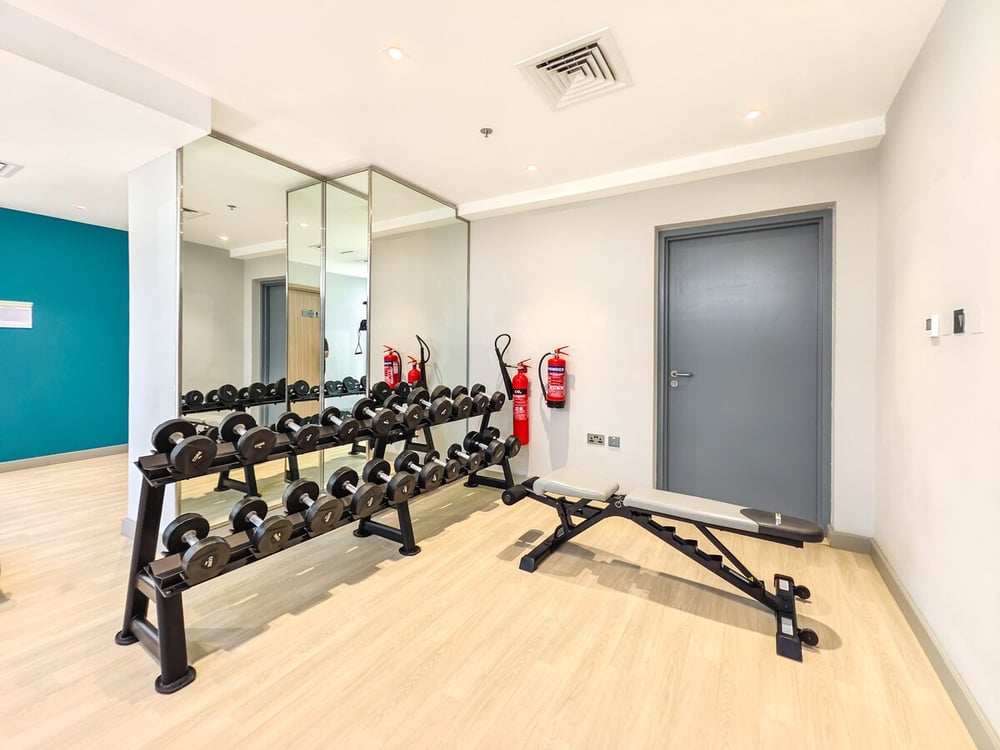 Gym with dumbbells bench and fire extinguisher