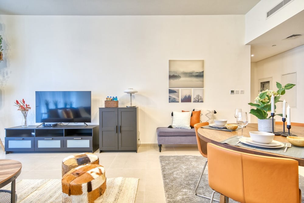 Living and dining area with TV unit and dining table
