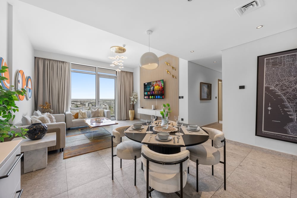 Living and dining area with TV and city view