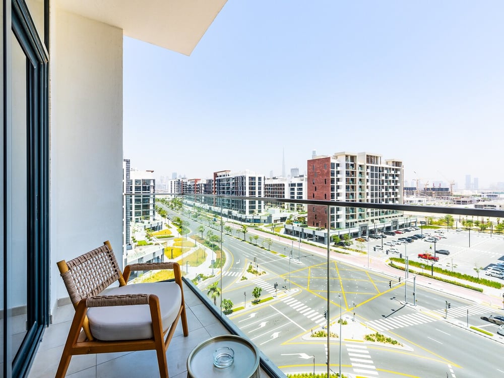 Balcony with chair and urban development view
