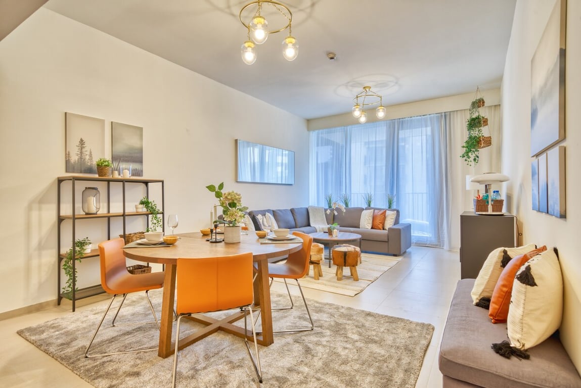 Open-plan living and dining area with round table and sofa