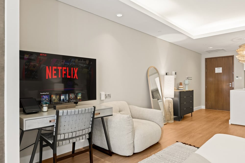 Studio sitting area with Netflix TV, work desk and sofa