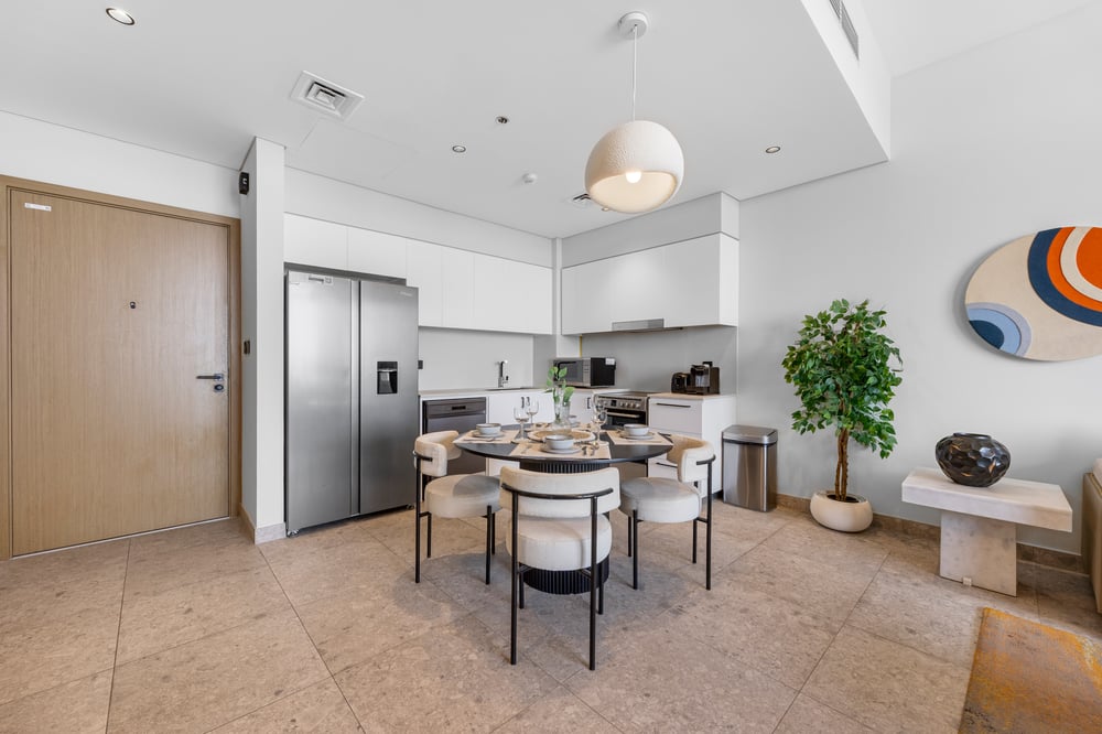 Open-plan kitchen dining and living area with plant
