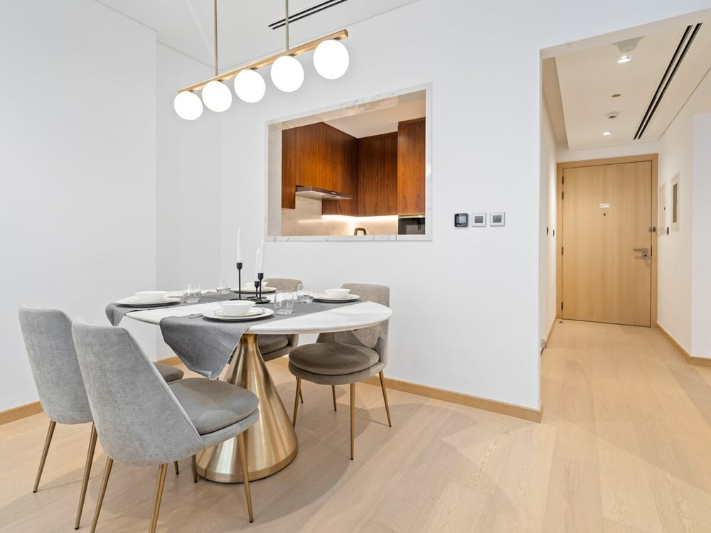 Dining area with round table and grey chairs