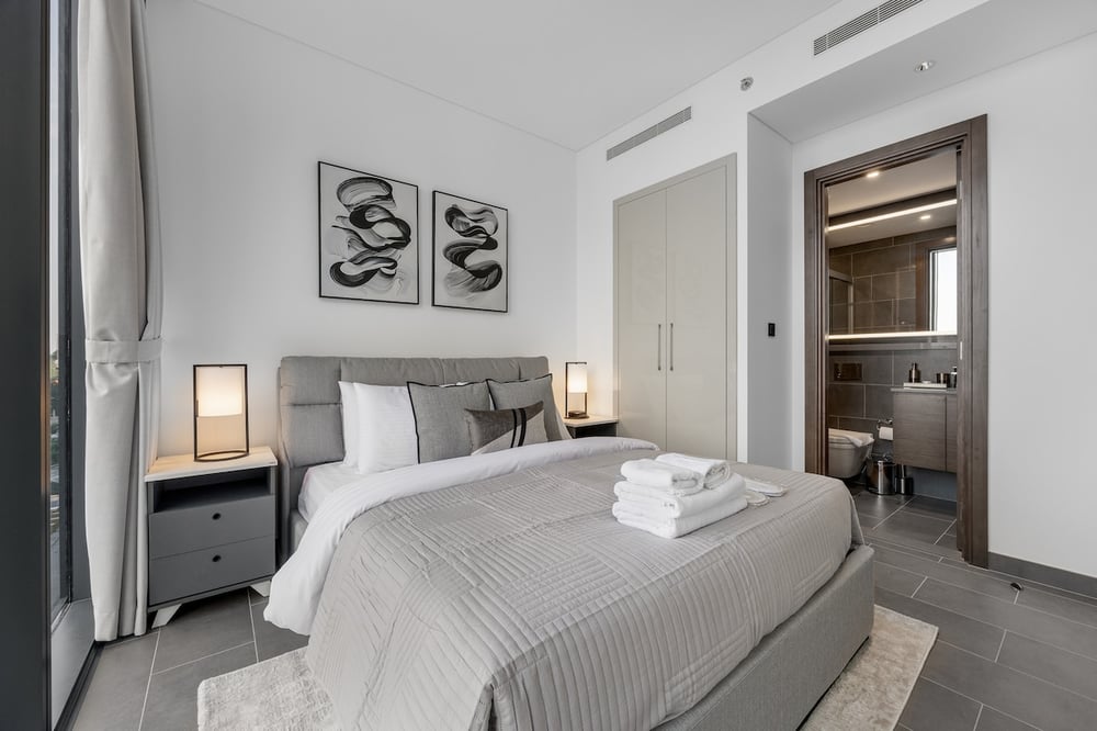 Bedroom with double bed and en-suite bathroom door