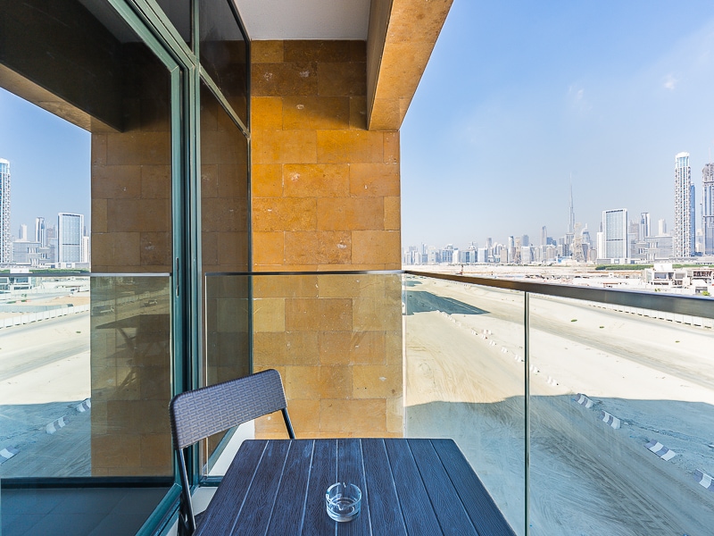 Balcony with glass railing and city skyline view