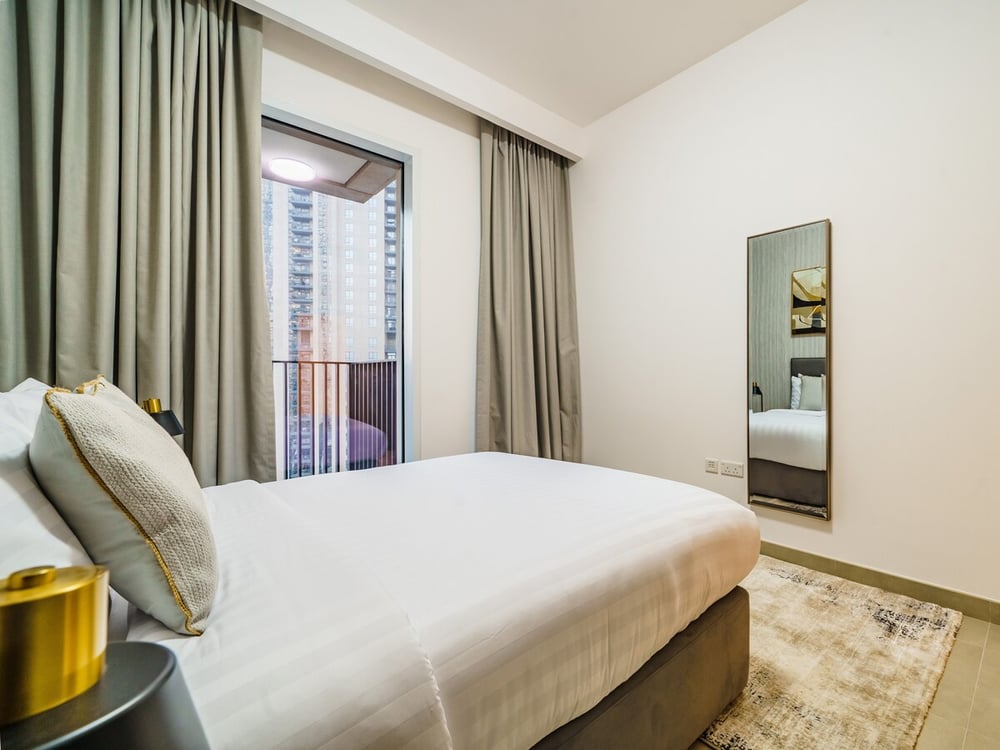 Second bedroom with a king bed, a balcony and a mirror