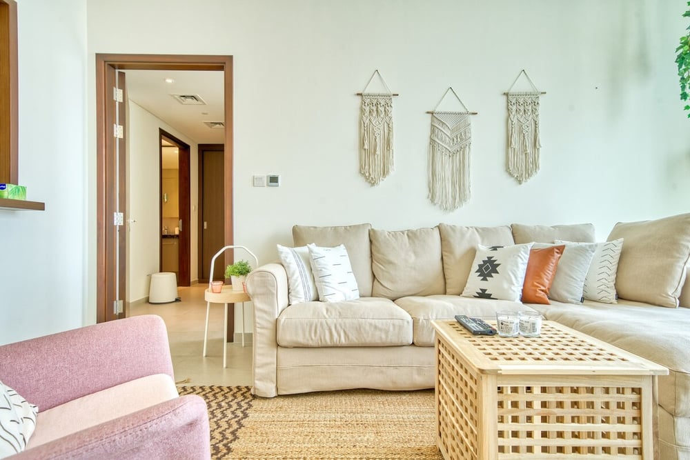 Living room with large corner sofa and hallway view