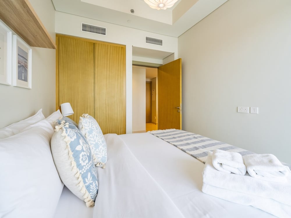 Bedroom with double bed, wardrobe and natural light