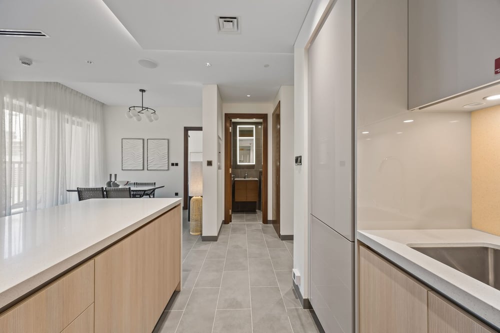 Kitchen island and hallway leading to rooms