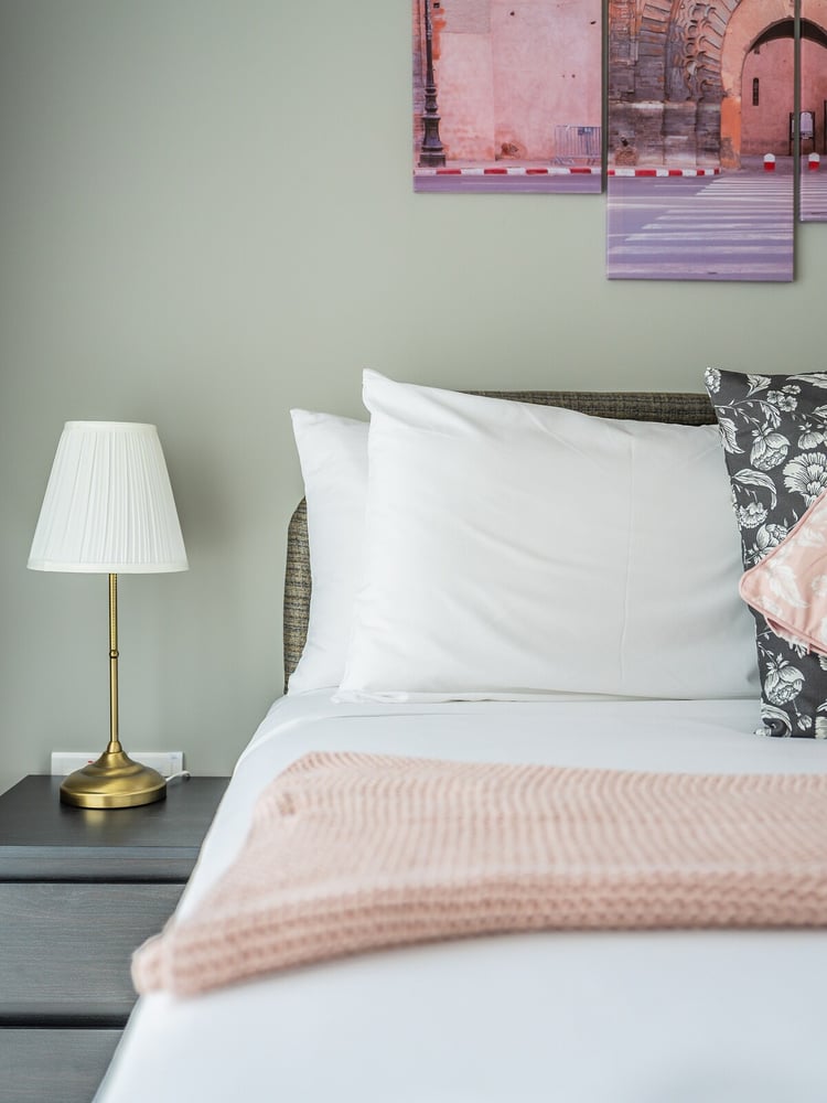 Bedroom pillow detail with bedside lamp
