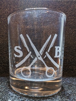Whiskey glass with Sam Cuts logo engraving
