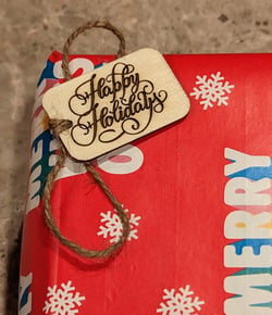 Wooden gift tag that says Happy Holidays